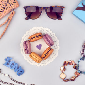 Overhead outfit Fashion clothes set, macarons french dessert, accessories. Glamor creative, love, clutch sunglasses gift box, necklace, bracelet. Unusual modern party essentials.Top view,background